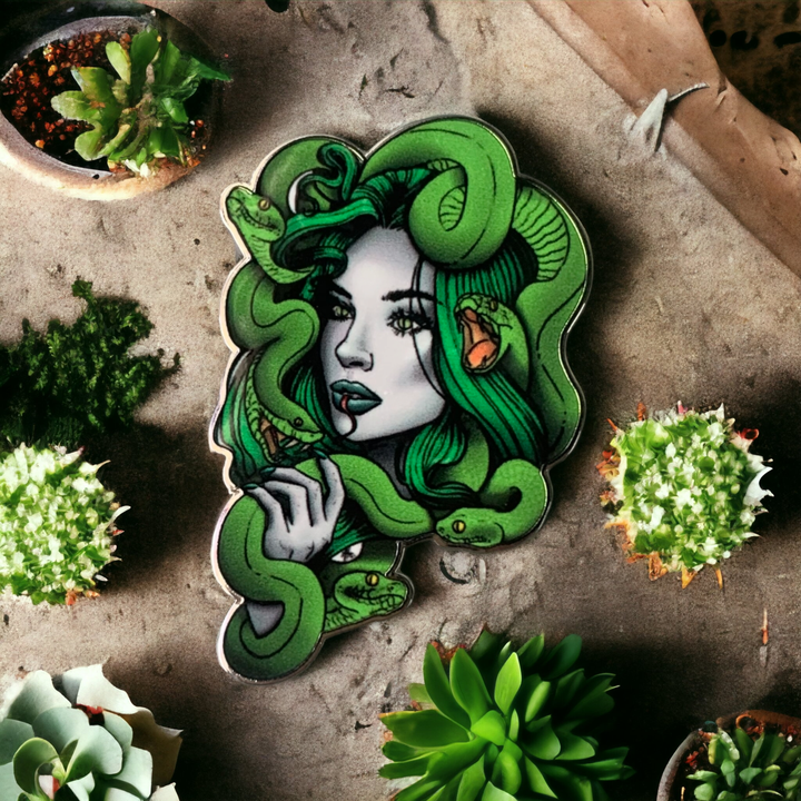 Medusa enamel pin shown on backing card