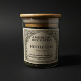 Dried cut-and-sifted nettle leaf (Urtica dioica) in a labeled glass ritual herb jar
