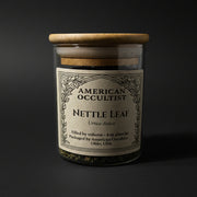 Dried cut-and-sifted nettle leaf (Urtica dioica) in a labeled glass ritual herb jar
