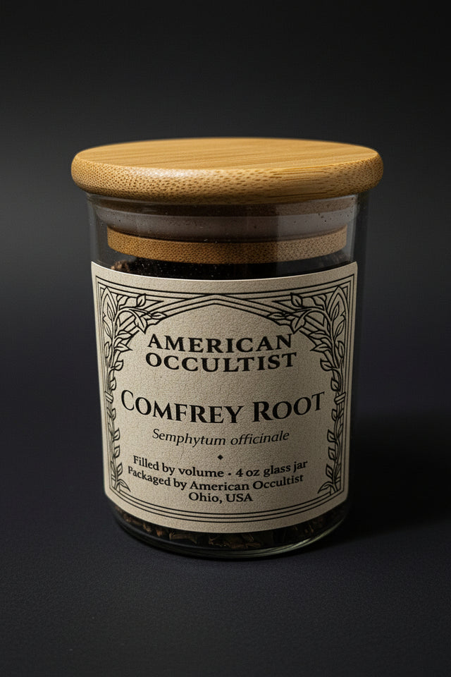 Bottle labeled 'American Occultist Comfrey Root' on a marble surface