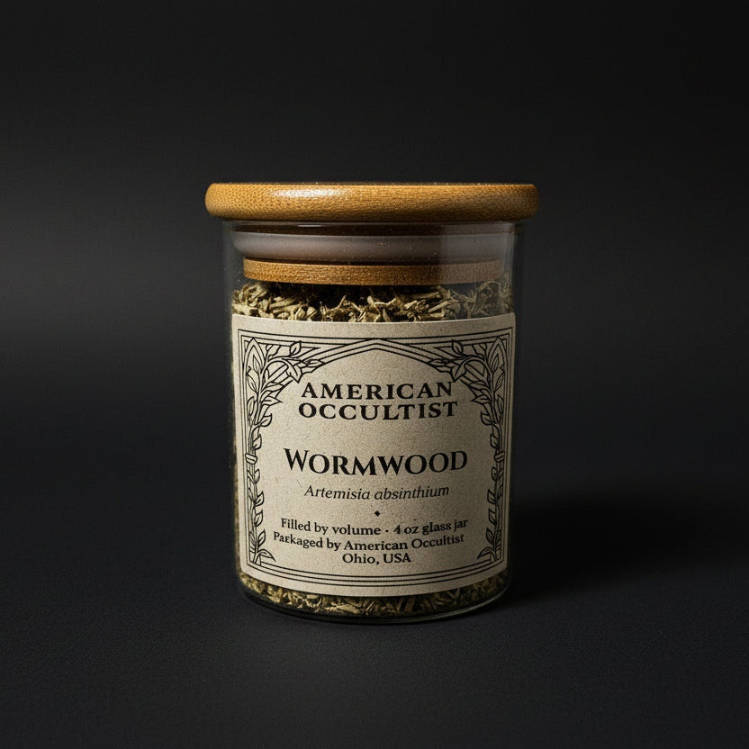 Dried cut-and-sifted wormwood leaf and stem (Artemisia absinthium) in a labeled glass ritual herb jar