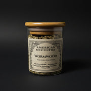 Dried cut-and-sifted wormwood leaf and stem (Artemisia absinthium) in a labeled glass ritual herb jar