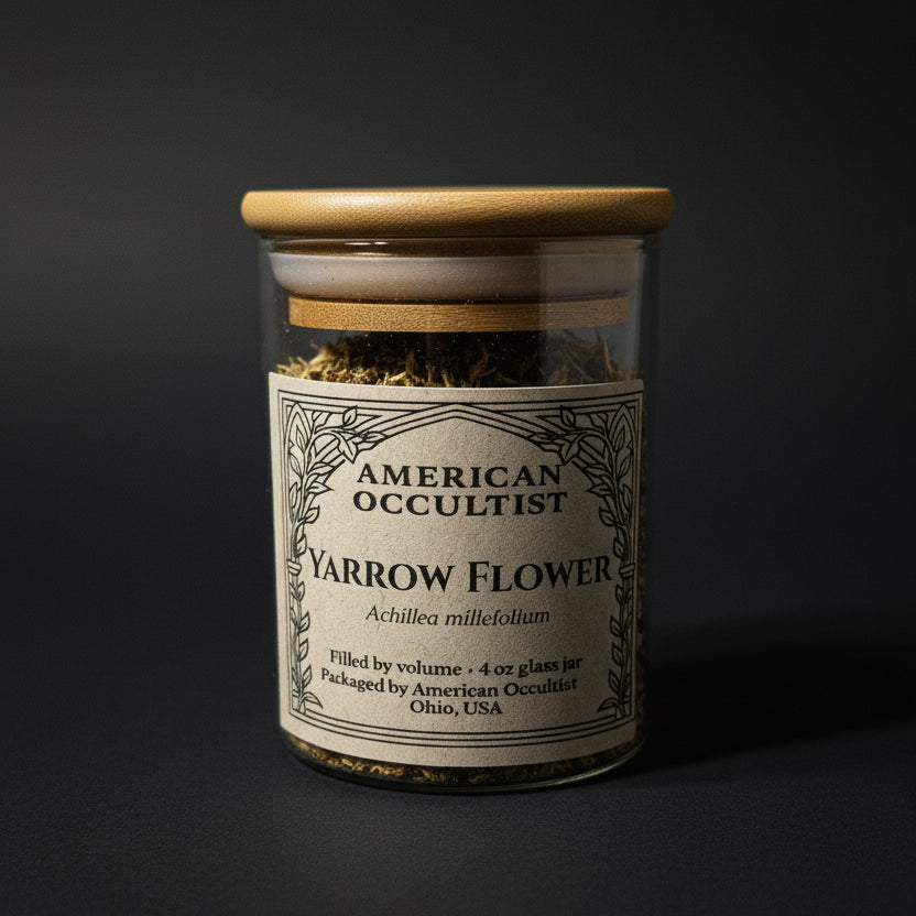 Dried cut-and-sifted yarrow flower material (Achillea millefolium) in a labeled glass ritual herb jar