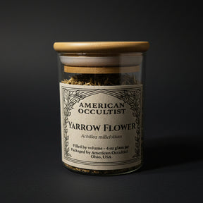 Jar of American Occultist Yarrow Flower on a marble surface