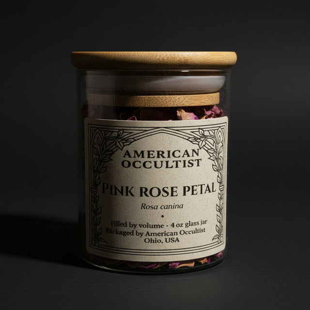 American Occuiltist jar of pink rose petals on a black background