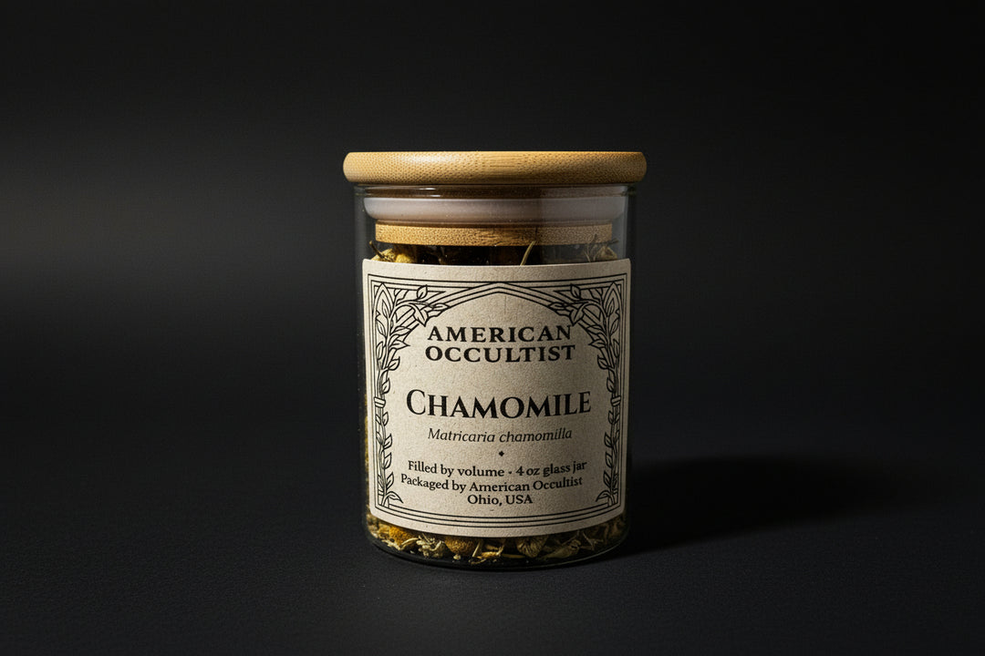 Dried German chamomile flowers (Matricaria chamomilla) in a labeled glass ritual herb jar