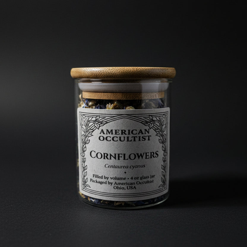 Whole dried cornflowers (Centaurea cyanus) in a labeled glass ritual herb jar