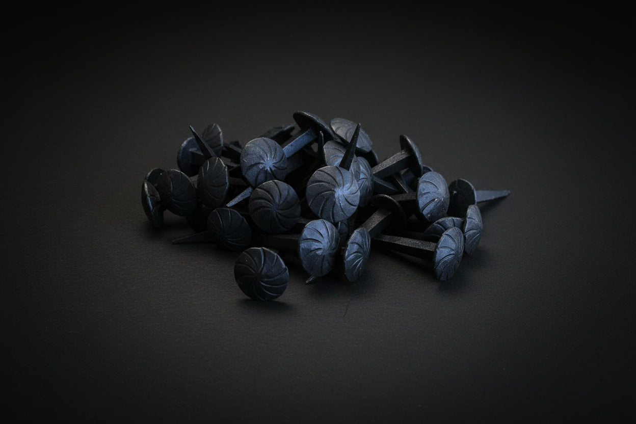 Black decorative nails on a wooden surface