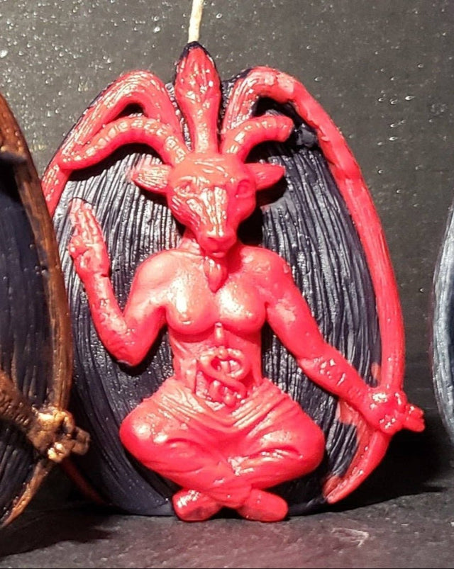 Red demon-like figure with horns on a black background
