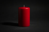 Red candle on a white background