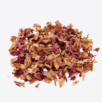 Dried pink rose and brown flower petals on a white background