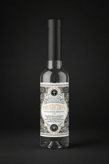 Two bottles of 'Protection' cleansing water with decorative labels on a black background