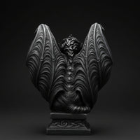 Back view of a winged gargoyle statue with raised wings