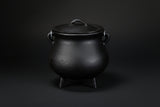 Plain black cast iron cauldron with three legs and lid