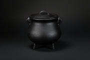 Plain black cast iron cauldron with three legs and lid
