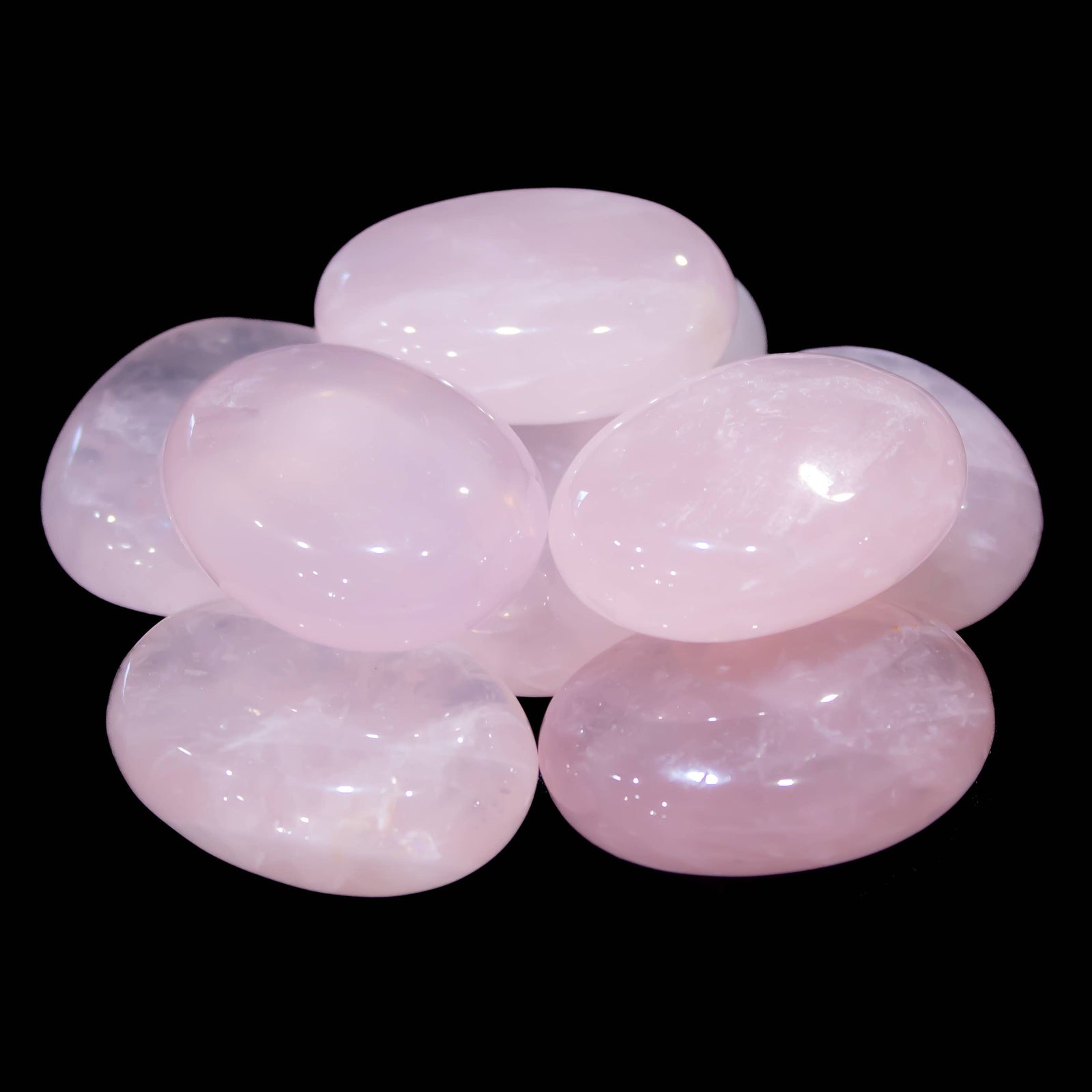 Rose Quartz palm stone shown in hand for scale