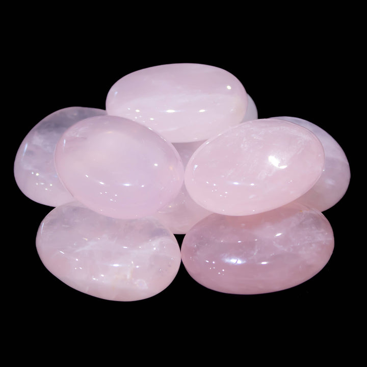 Rose Quartz palm stone shown in hand for scale