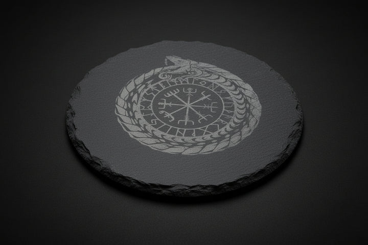 Round slate altar tile engraved with Nordic ouroboros and runic-style symbol used as a ritual surface.