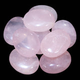 Polished Rose Quartz palm stone with pale pink color and cloudy translucency