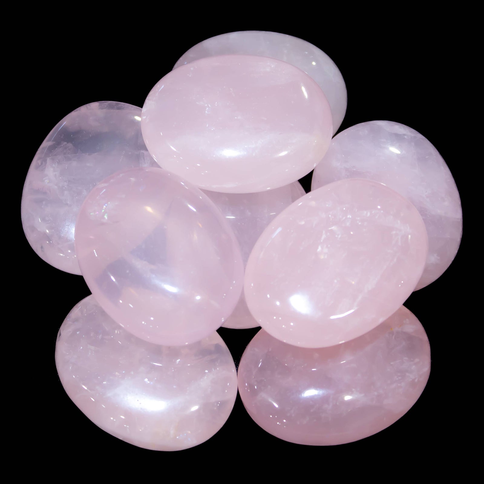 Polished Rose Quartz palm stone with pale pink color and cloudy translucency