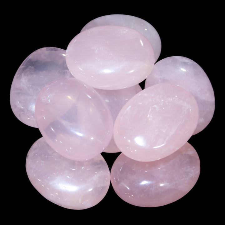 Polished Rose Quartz palm stone with pale pink color and cloudy translucency