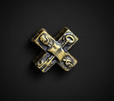 Crossroads-shaped ritual candle photographed against a black background