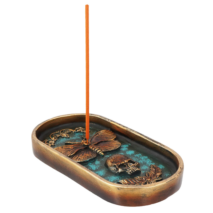 Moth and skull burner shown with incense