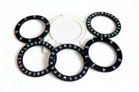 Black rings with letters and numbers on a white background
