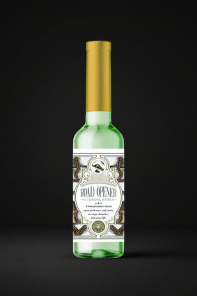 One green bottle with gold cap on a black background