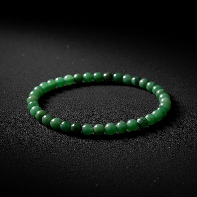 Representative stretch bracelet sold as African Green Jade with polished green beads; color, pattern, bead size, and fit vary