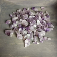 Amethyst crystals on a gray surface