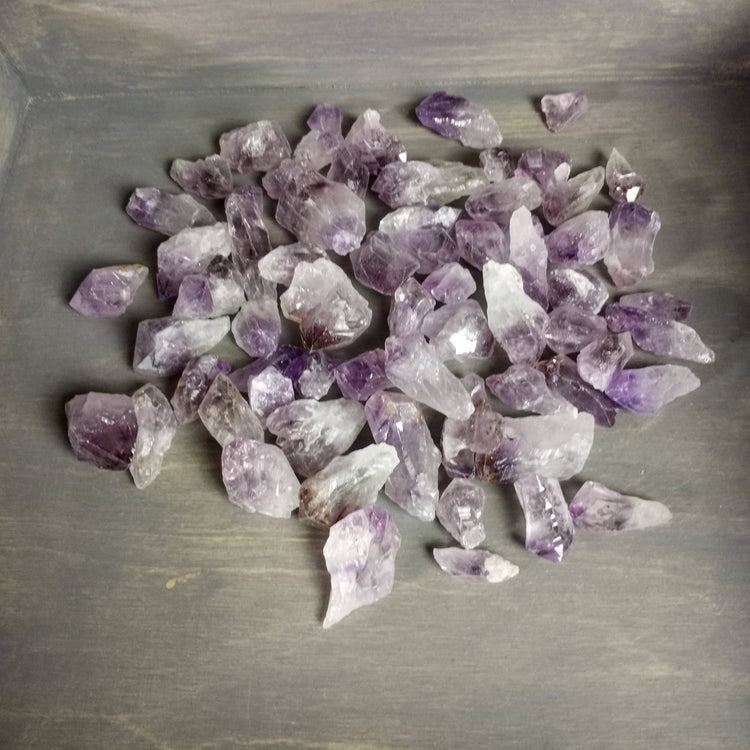 Amethyst crystals on a gray surface