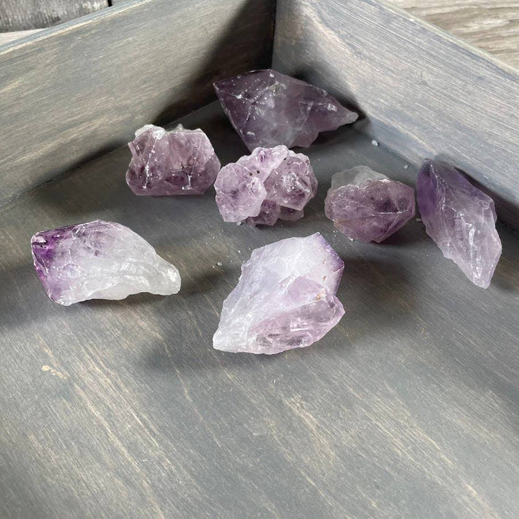 Amethyst crystals on a wooden surface