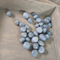 Blue stones on a wooden surface