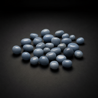 Polished pale blue Angelite tumbled stones arranged on a matte black surface