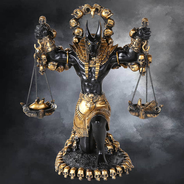 Statue of a deity with scales and skulls on a dark background