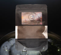 Black packaging with a label featuring text and graphics on a dark background