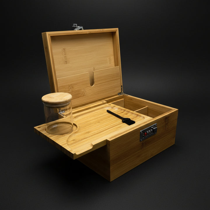 Large wooden stash box with lock, compartments, glass jar, and brush tool for organizing ritual supplies.