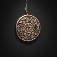 Terracotta wall plaque with pentacle, triple moon symbols, and vine detailing for altar and ritual display.