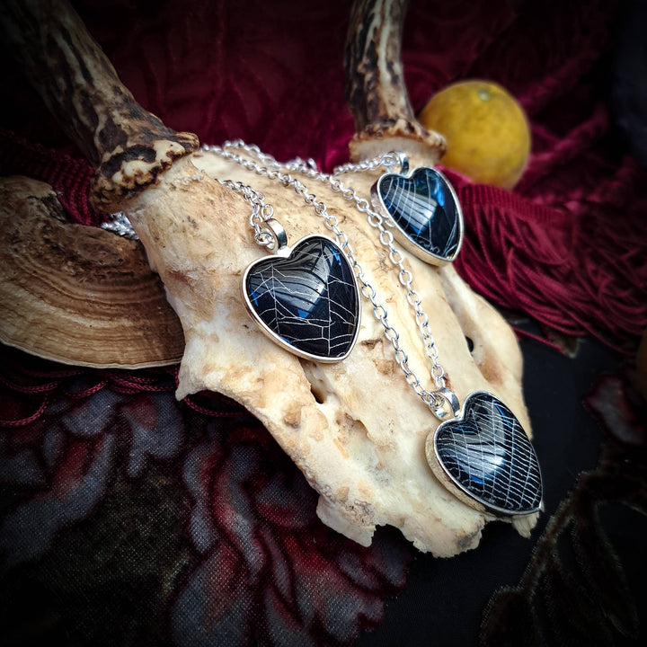 Spiderweb heart necklace shown on chain