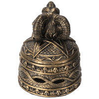 Decorative bronze object with ram's head on a white background