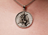 A close-up image of a person wearing a Baphomet pendant necklace.