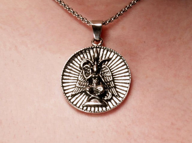 A close-up image of a person wearing a Baphomet pendant necklace.