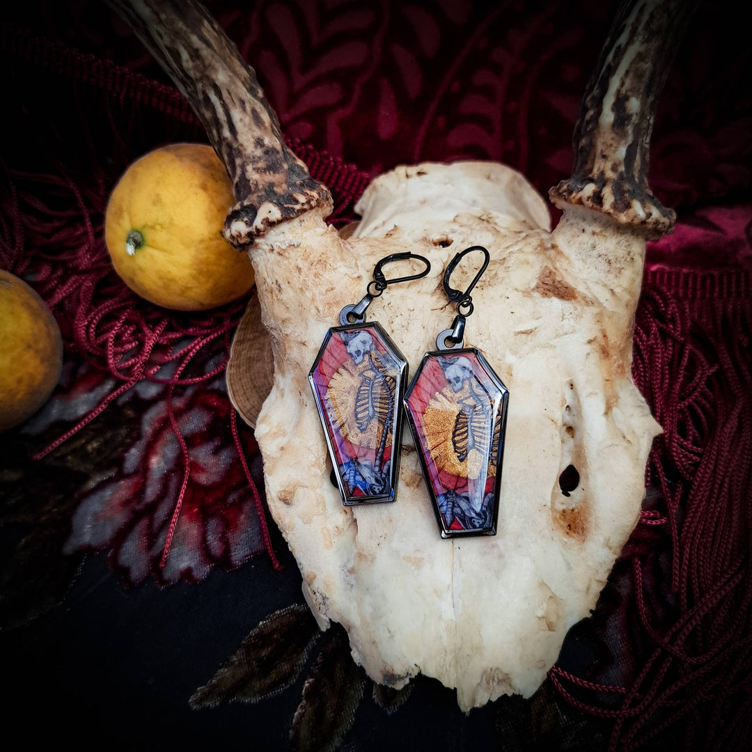Skull and Savior black earring artwork close-up
