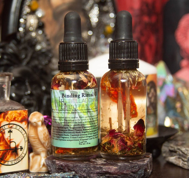 Two dropper bottles labeled 'Binding Ritual' on a mystical background with candles and stones.
