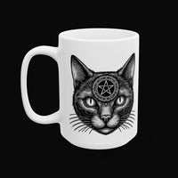 a white mug with a black cat on it on a black background.