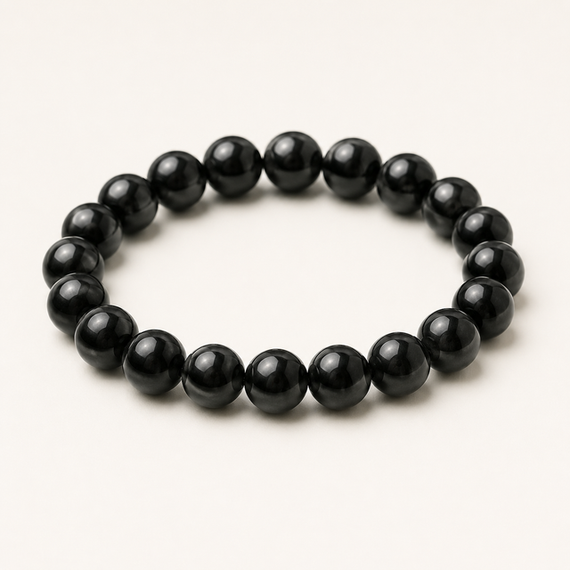 Representative stretch bracelet sold as Black Obsidian with polished round black beads; color, bead size, surface details, and fit vary