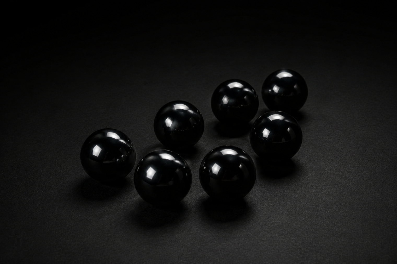 Representative assortment of glossy black spheres sold as Obsidian; volcanic-glass identity, treatment, selected 30 mm, 40 mm, or 120 mm size, polish, and exact condition vary