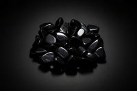 Representative polished black stones sold as Black Obsidian; shape, translucency, polish, and size vary