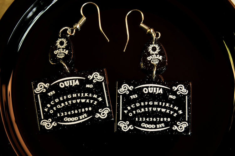 ouija board earrings black background